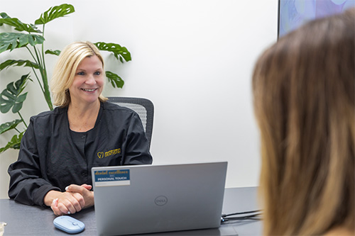 Dental team member talking to dental patient