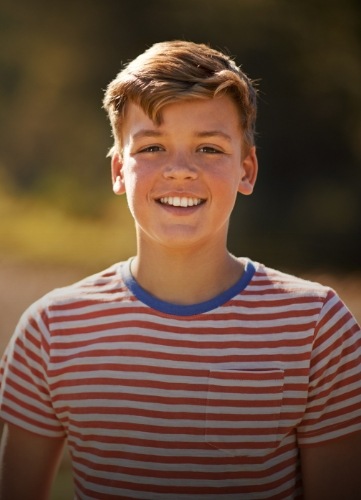 Teen boy smiling after children's dentistry