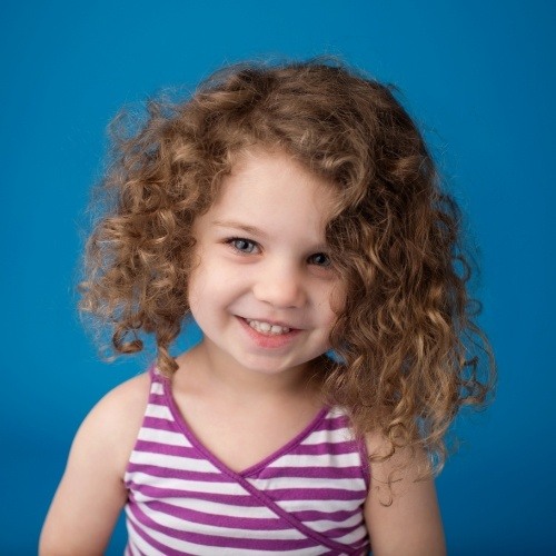 Young girl smiling after children's dentistry checkup and teeth cleaning