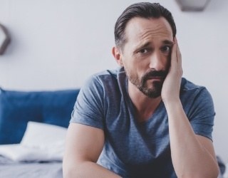 Man with toothache holding cheek