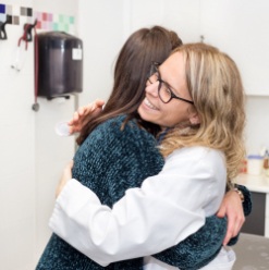 Woman hugging dentist