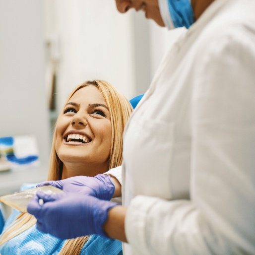 Woman in dental chair laughing