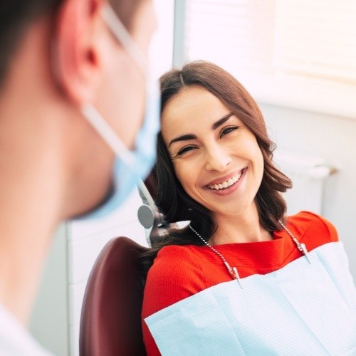 Woman smiling during preventive dentistry checkup and teeth cleaning visit