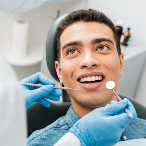 Man receiving oral cancer screening