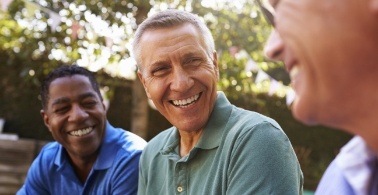 Man sharing heatlhy smile after replacing missing teeth