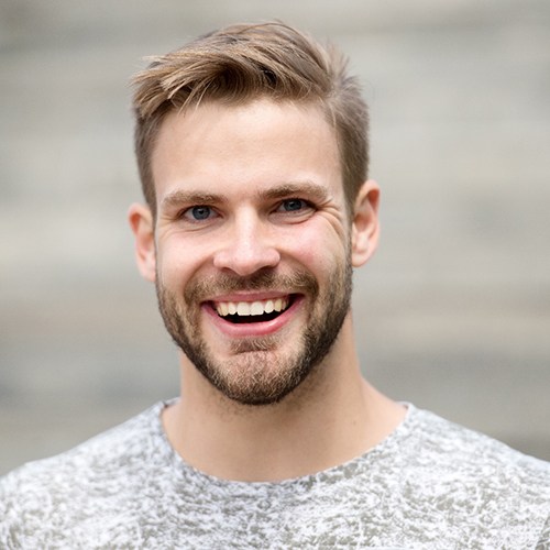 man smiling after getting veneers in Holliston 